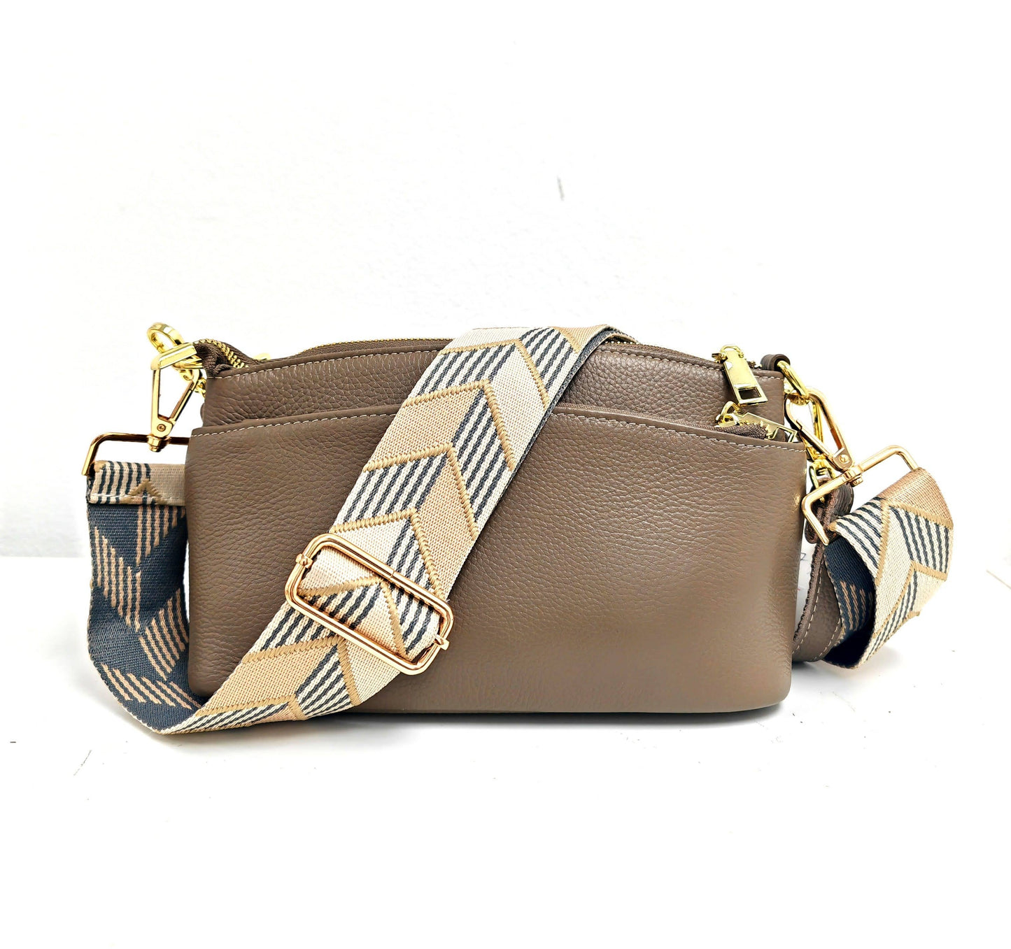 Brown handbag with a patterned strap